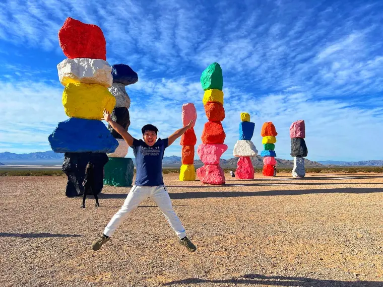 Happy guy with a 7 Magic Mountains in the background